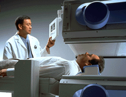 A technolgoist positions a patient for nuclear medicine scan
