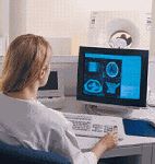 A CT technologist and patient communicate