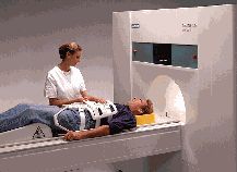 Technologist prepares a person for an MRI scan