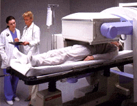A radiologist and technologist observe an exam